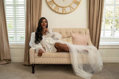 Elegant bridal editorial portrait on tufted sofa before wedding ceremony at Ritz Charles in Carmel Indiana.