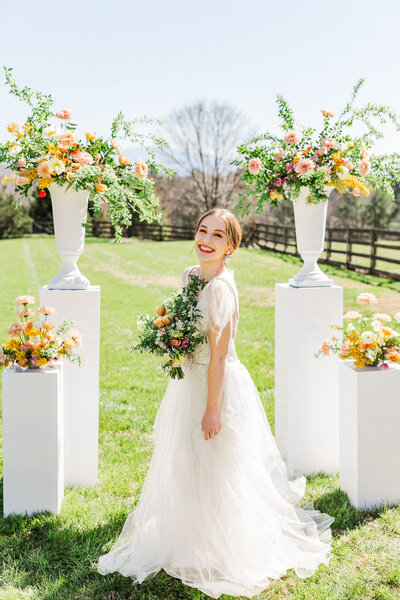 Happy  joyful bride Bridal portrait mountains in the background with bright colorful florals.
