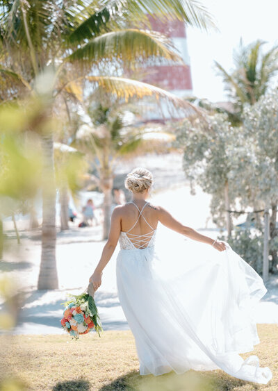 a bride at her Bahamas wedding twirling captured by a destination wedding photographer