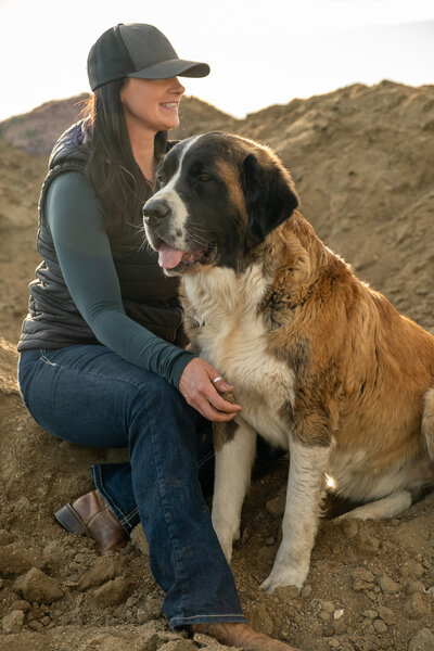 Janelle Robinson and her pet dog at Spirit's Respite Ranch, a peaceful sanctuary offering equine therapy and a healing environment near Calgary, Alberta