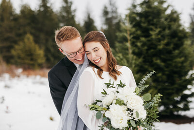 Couple laughing in a field of blue wildflowers