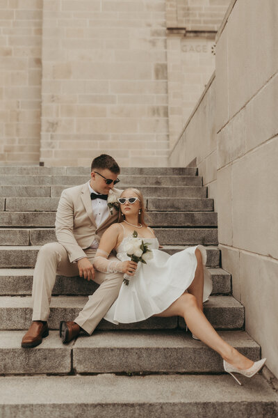 Bride + Groom slip on each others wedding rings after their ceremony