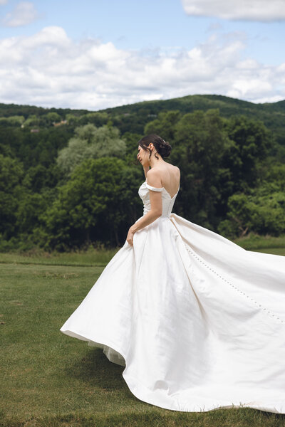 Bride twirling in wedding gown on a lush green lawn in Philadelphia