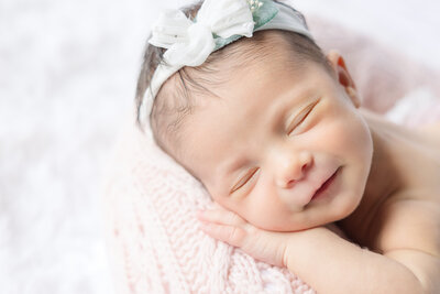 Newborn baby girl with pink crown