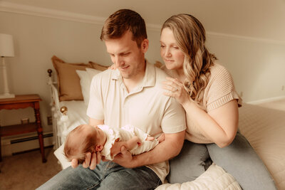 A family posing for a newborn session in a  home in New Jersey