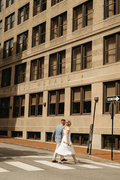 A couple walks around Portland, Maine downtown after their City Hall elopement 