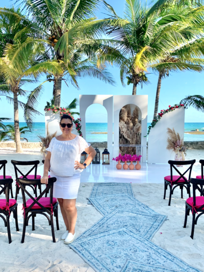 Destination wedding planner Christine Terezakis at colorful beachfront ceremony site Mexico