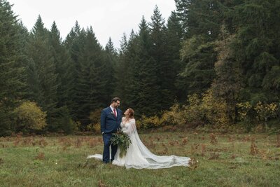 Happy elopement couple with Mount Rainier and a forest as a backdrop