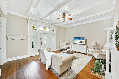 Spacious living area with flat screen TV and ample seating in historic vacation rental home in downtown Waco, TX