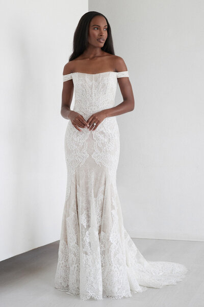 Our Spruce gown, constructed from our Anjo lace, features a high neck, puff sleeves and a dramatic open keyhole back. The scalloped lace cuffs add a unique yet romantic touch.