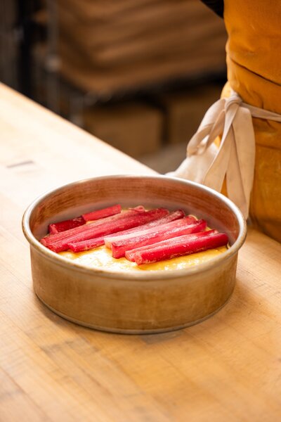 Handmade gluten-free rhubarb cake in a golden baking tin at Grain Artisan Bakery.