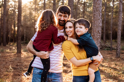 Outdoor photo at sunset with family of four