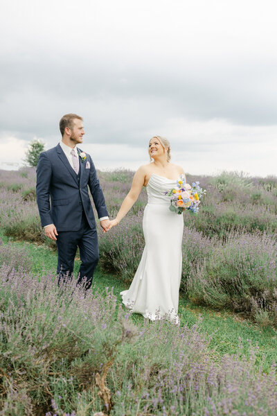 A bride and groom kissing with veil blowing in the wind