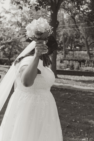 photo of bride holding up bouquet of flowers