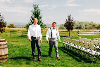 Groom and dad walking on ceremony lawn at U Diamond Barn in Helena, MT