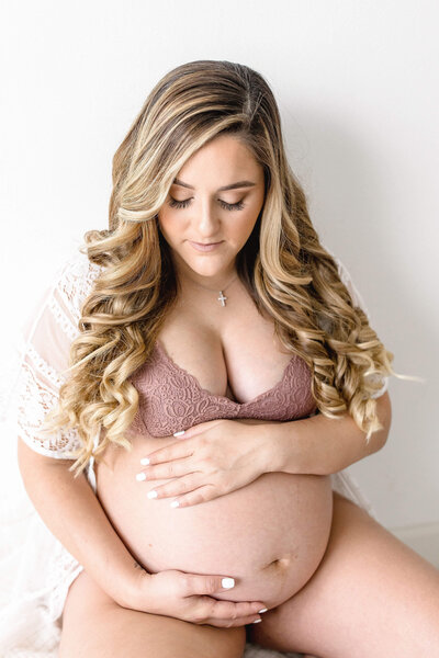 Couple walking down the beach  with their Miami Maternity Photographer Ivanna Vidal Photography