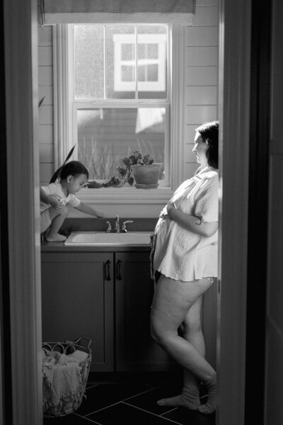 Woman with child in bright laundry room
