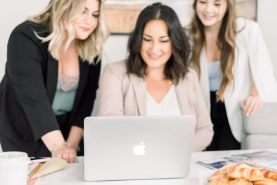 three women working on a computer