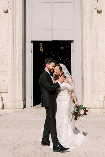 Bride and groom embrace on the balcony of Cabo Azul resort in Los Cabos Mexico