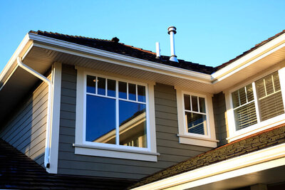 Newly installed window on a house exterior by Black Bear Roofing & Exteriors.