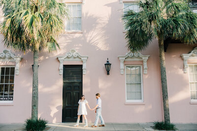 Couple embracing under trees with Spanish moss