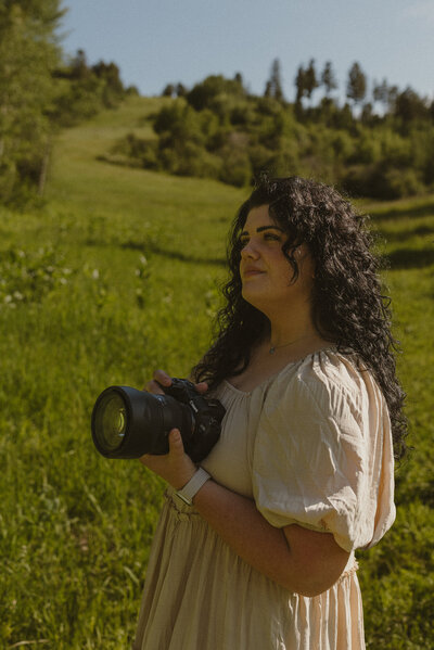 Brigette twirling outside in a white dress.