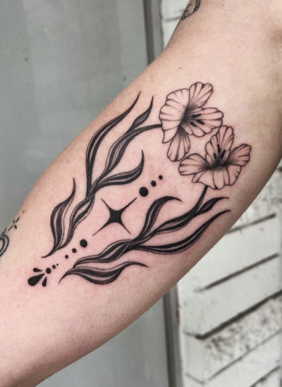 Line tattoo of reversed faces on arm