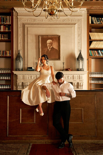 An engaged couple being photographed in Aldrich Mansion in Warwick Rhode Island