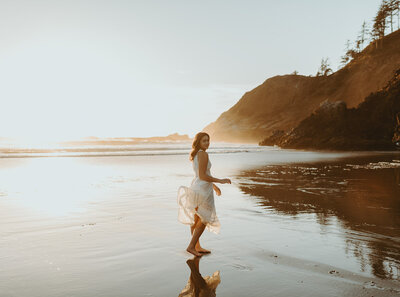 girl standing on oregon coast beach