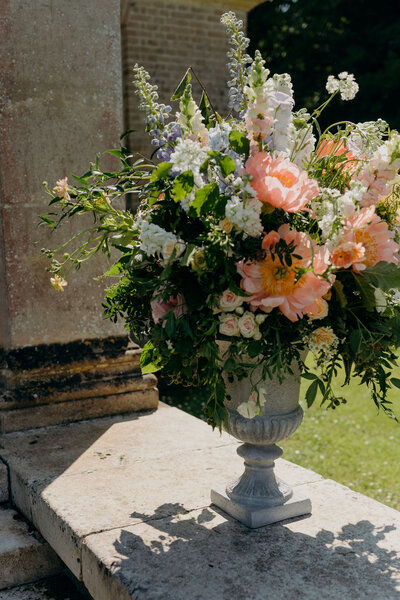 organic natural rambling urn of flowers outdoor wedding