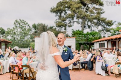 Bride and Groom share their first dance at an outdoor venue in San Clemente