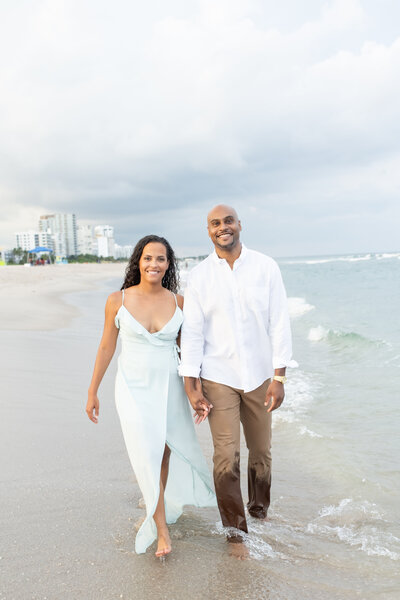 Couple walking Naples Florida shoreline