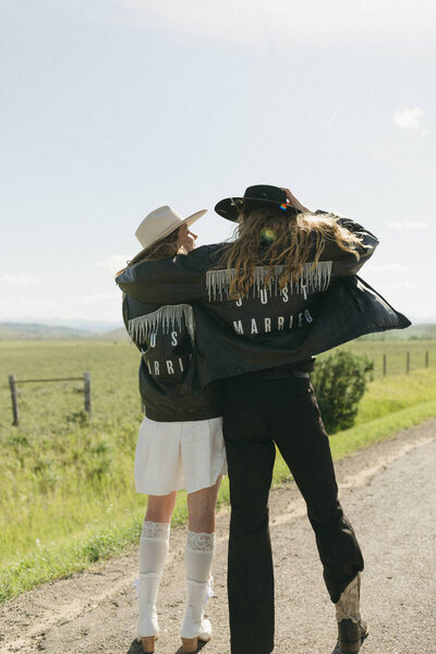 bride and groom wearing just married leather fringe jackets