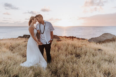 Destination Wedding Photographer captures bride and groom touching foreheads after intimate Hawaii beach wedding