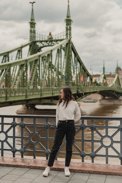 Girl in Budapest Hungary standing in front of Liberty Bridge