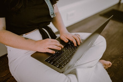 Business woman typing on keyboard