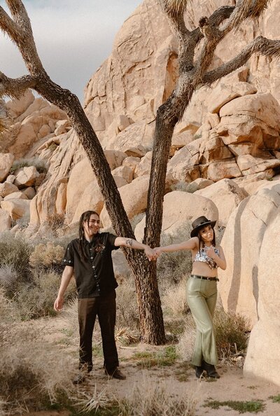 Couple walking up beach steps on the side of a cliff