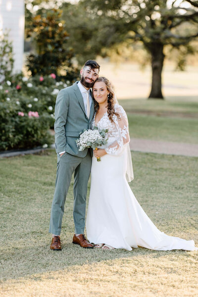 bridal portrait of bride in white wedding dress standing in chapel doors at Four Fifteen Estates in New Boston, TX