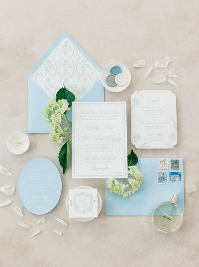 blue white and green wedding flatlay invitations 