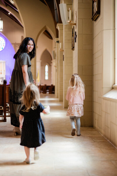 a young woman reading the Bible in a Catholic church