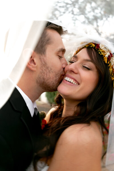 Husband kissing wife on the cheek