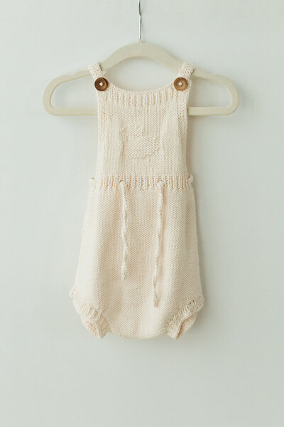 baby’s white knit onesie