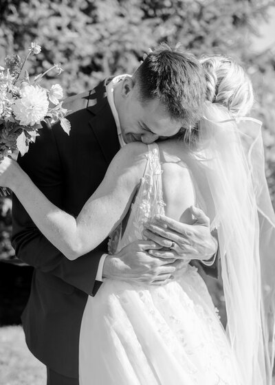 bride and groom holding hands walking in field