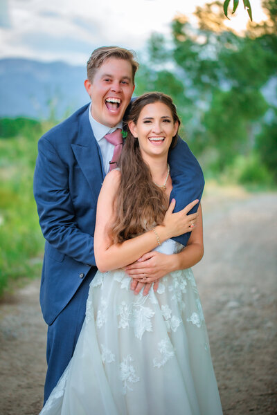 Jackson Hole photographers capture intimate outdoor elopement with couple smiling and laughing together