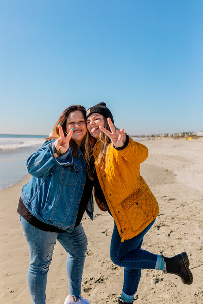 Friends posing at the beach with peace signs