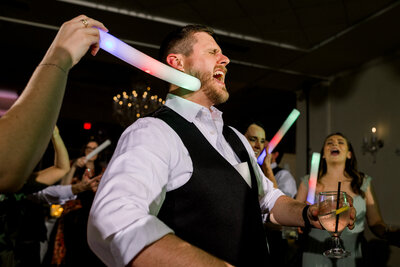 Groomsman dancing at a wedding reception at Ashton Gardens Atlanta