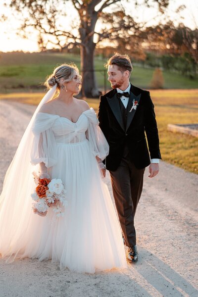 Couple in wedding attire on the beach.