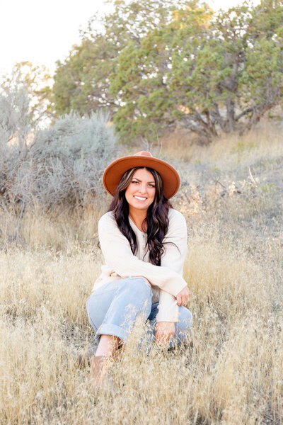 Eagle Mountain based photographer sitting in some sage brush in a beautiful desert.