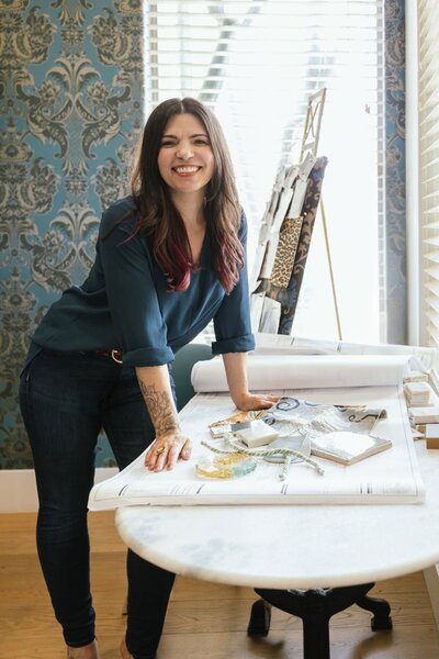 Stephanie Stuart, luxury interior designer in Peoria and Vistancia AZ, working with material samples and mood boards in her design studio