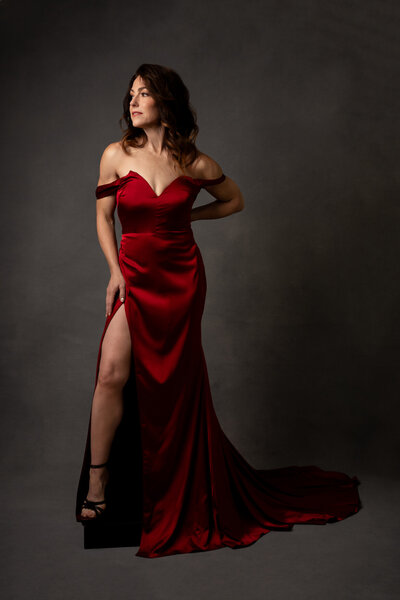 Portrait of a woman with medium brown hair wearing a red gown